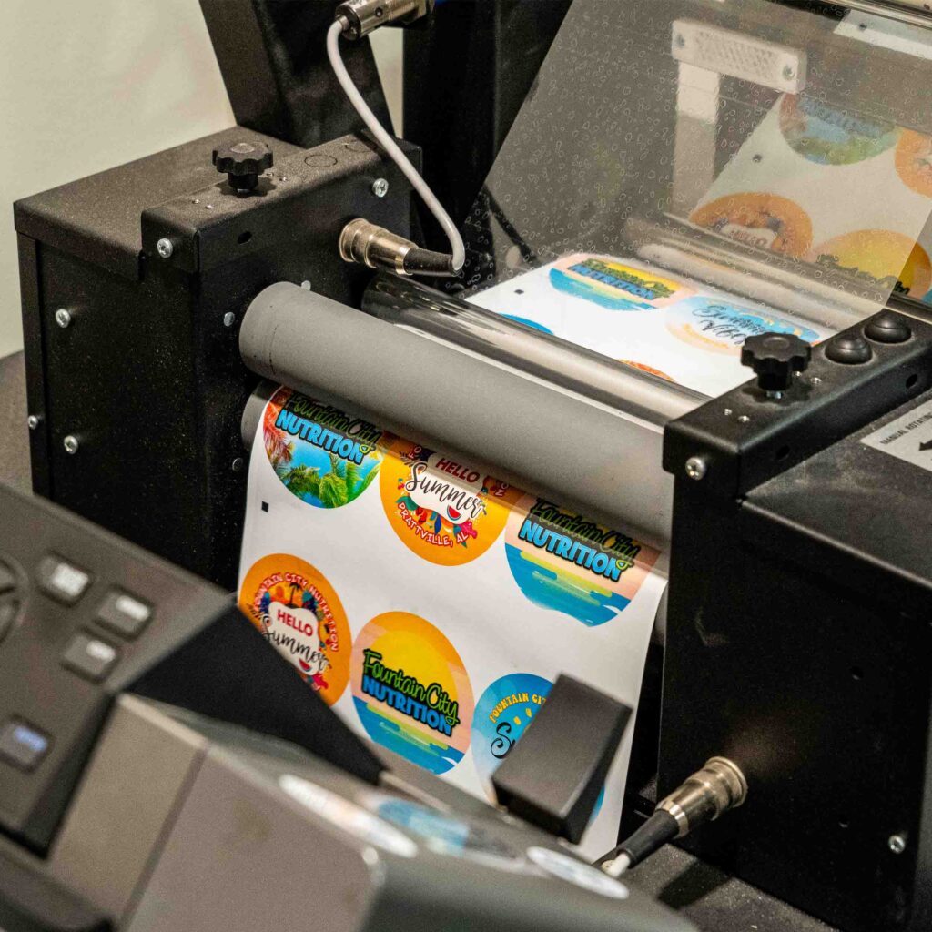 Round labels being printed and laminated.